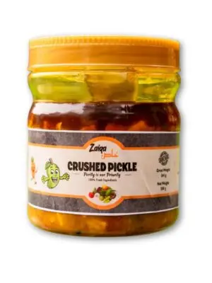 A product shot of a jar of Zaiqa Khas Crushed Pickle, featuring a brown label with the brand name and product description.